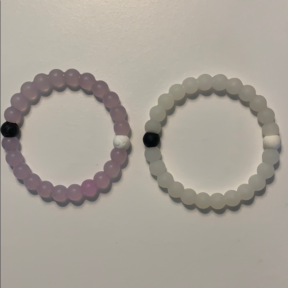 2 lokai bracelets: purple and white